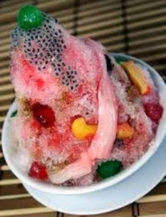 a white bowl filled with fruit on top of a table