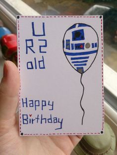 a hand holding up a card with a star wars character on it that says happy birthday