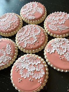 six decorated cookies sitting on top of a table