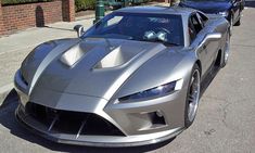 a silver sports car is parked on the street