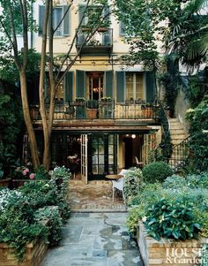 an apartment building with lots of trees and plants