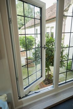 an open window in a house with a potted plant