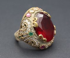 Beautiful Turkish 925K sterling Silver & Bronze ring. Its %100 hand crafted workmanship with beautiful glass Ruby stones with zircon beads. Please do not hesitate to contact if you have any questions. Weight : 14.9 grams,  Ring Size 8.5 on US Jewelries Ring mandrel,  Shipping & Estimated Delivery Time With Turkish Registered Post, Destination CountryStandard Shipping (business days) United States          15-20  Europe7-15 Asia15-25  Australia15-20 Brazil & South America Antique Ruby Rings As Gift, Traditional Oval Ruby Ring As Gift, Oval Ruby Ring As Gift, Traditional Red Ring Stamped 925, Traditional Red Ruby Ring With Stone Setting, Gift Ruby Ring With Stone Setting, Collectible Red Gemstone Rings, Red Stone Setting Ring Gift, Handmade Red Crystal Ring For Wedding