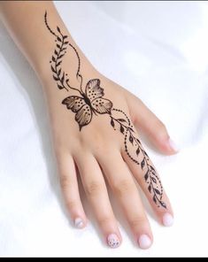 a woman's hand with hennap and flowers on the left side of her arm