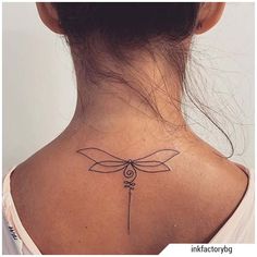 a woman's back neck with a dragonfly tattoo on it