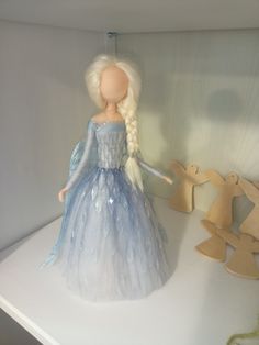 there is a doll that is on the shelf