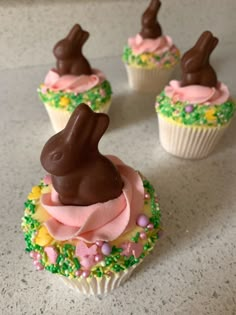 four cupcakes decorated with chocolate bunny ears