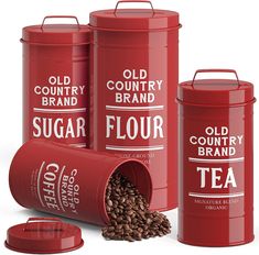 three red canisters filled with coffee beans next to each other on a white background