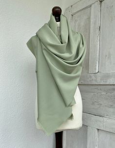 "It is made of a soft cotton fabric, which gives it a sage green color. You will look very elegant wearing this bridal tassel shawl. The pale green pashmina scarf makes for a brilliant and priceless gift.  Several ways can be used to wrap this long wrap around your neck, such as wrapping it twice or in one long wrap. This pashmina scarf is made of soft and quality cotton fabric. Are you looking for a unique gift for your maid of honor? For your bridesmaid or mother of the bride, this long sage g Green Shawl, Groom Dress Men, Bridesmaid Shawl, Mother Of The Bride Gift, Bridal Cover Up, Sage Wedding, Chiffon Shawl, Sage Green Wedding, Green Bridesmaid