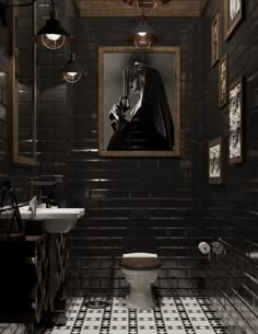 a black and white tiled bathroom with a painting on the wall above the toilet seat