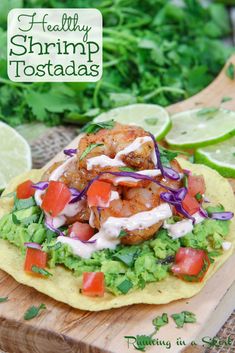 shrimp tostadas on a tortilla with lettuce and tomatoes