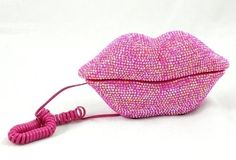 a pink purse with a cord attached to it