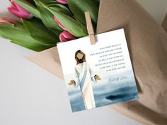 a card with the image of jesus holding a bouquet of tulips next to it