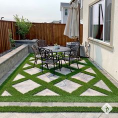 an outdoor patio with grass on the ground