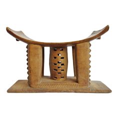 an old wooden stool with carvings on it