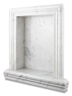 a white marble fireplace mantel with an open door