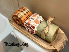 three wrapped gift bags sitting on top of a toilet