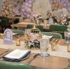 the table is set with purple and green decorations