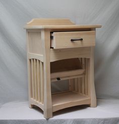 a small wooden table with drawers on it