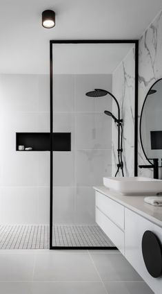 a bathroom with white tile and black accents