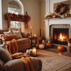 a living room filled with furniture and a fire place in front of a fireplace covered in pumpkins