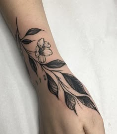 a woman's foot with a flower tattoo on it