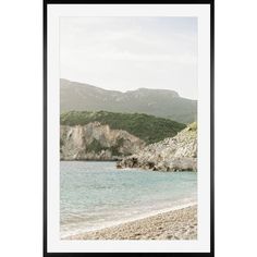 an image of a beach with mountains in the background, framed in black and white