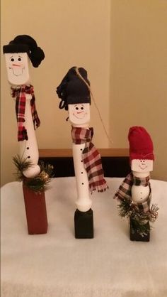 three snowmen standing on top of a table