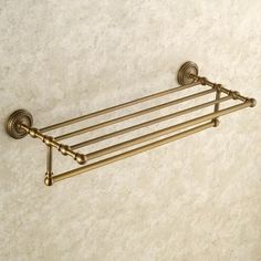 an old fashioned brass towel rack on the wall