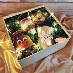 a box filled with christmas decorations on top of a bed