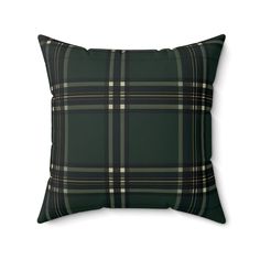 a black and green plaid pillow on a white background