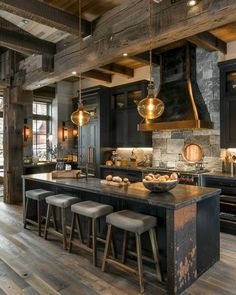 a large kitchen with wooden floors and black cabinets, an island countertop and stools