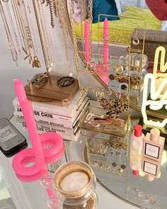 a table topped with lots of different types of jewelry and other items on top of it