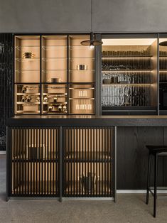 an empty bar with shelves and stools in front of it, next to a counter