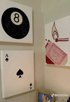 some cards are hanging on the wall next to each other with pictures and playing cards