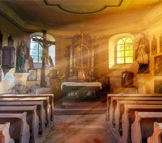 an old church with wooden pews and paintings on the walls