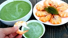 two bowls filled with green soup and shrimp