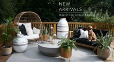 a dog sitting on top of a wooden deck next to potted plants and furniture