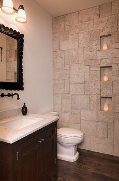 a bathroom with a white toilet sitting next to a sink