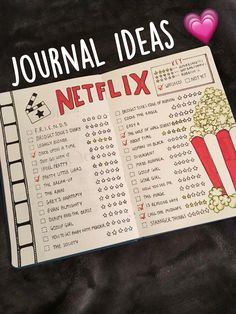 a notebook with the words journal ideas on it and a cup of popcorn next to it