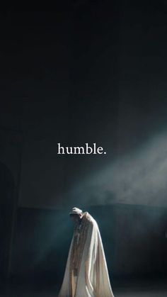 a woman standing in the dark with her back turned to the camera and text that reads, humble