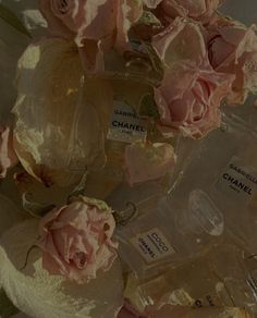 some pink roses and chanel perfume bottles