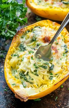 an egg dish with spinach and cheese in a yellow casserole dish, topped with a spoon