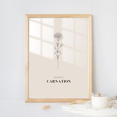 a framed poster with a flower and the words carnation on it