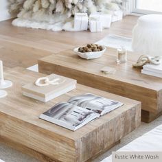 two coffee tables with magazines and candles on them