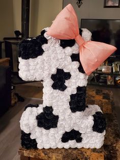 a cake made to look like a cow with a pink bow