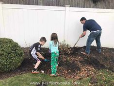 two children and an adult are digging in the yard