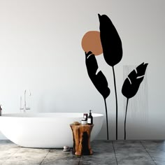 a bath tub sitting next to a white wall with black and orange designs on it