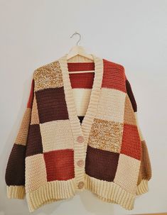 a cardigan sweater hanging on a hanger