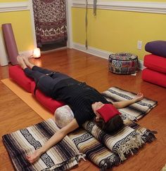 a woman laying on her back in a yoga position